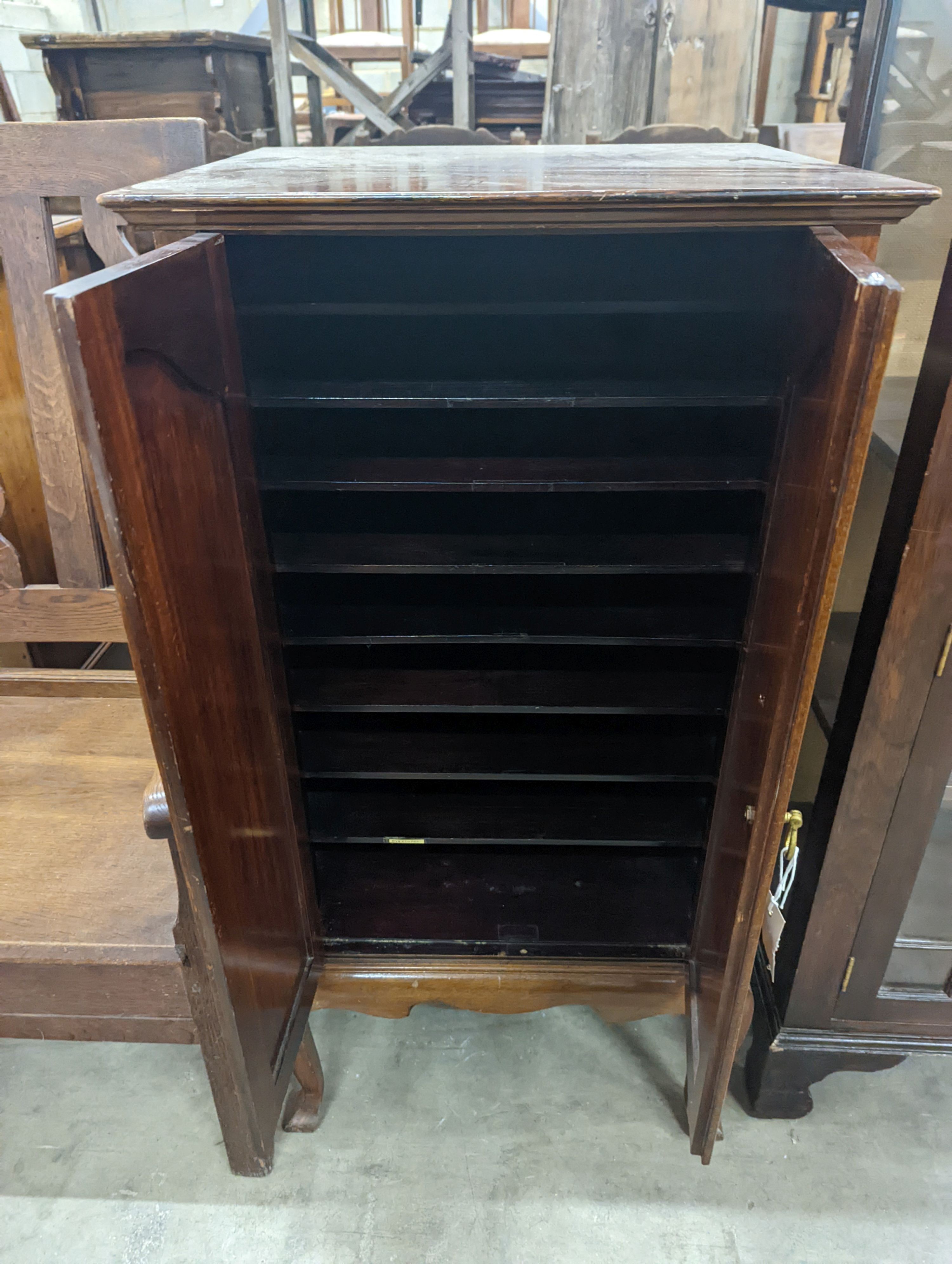 An Edwardian mahogany sheet music cabinet, width 52 cms, depth 46 cms, height 103 cms.